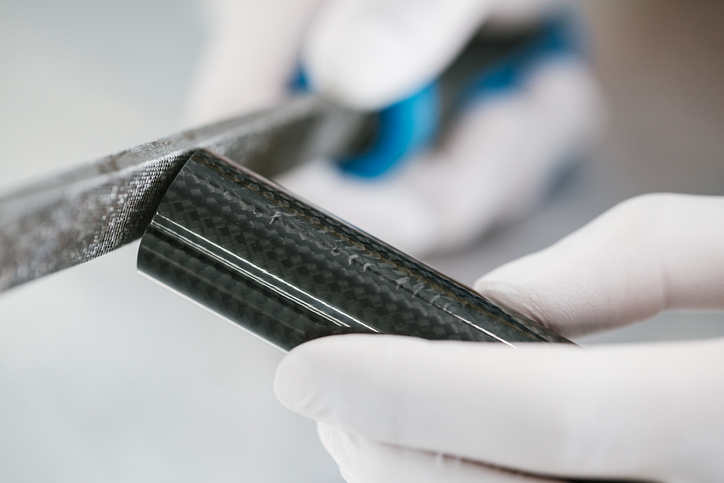 high performance heat shrink tape is essential to the production of carbon fiber parts, seen here being grinded and shaped