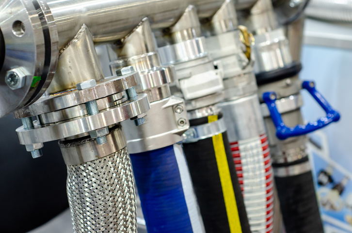 Multiple, and different, colored water hoses connected to industrial equipment rely on composite molding tapes in development.